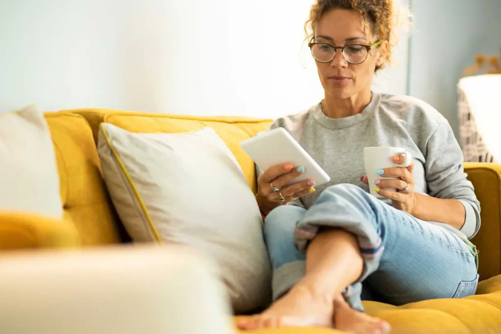 Girl on sofa looking at tablet